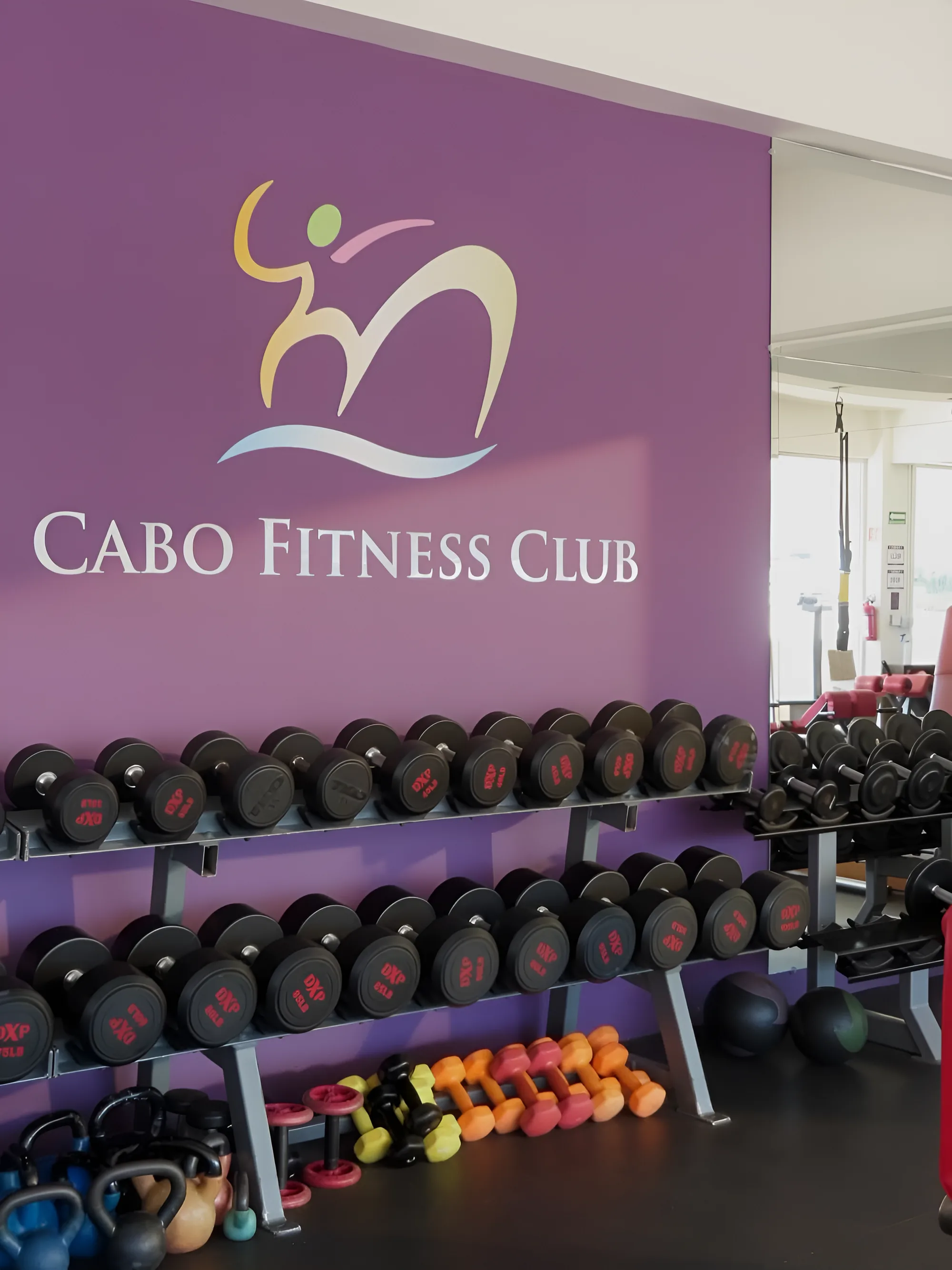 Cabo Fitness Club dumbbell wall with brand logo